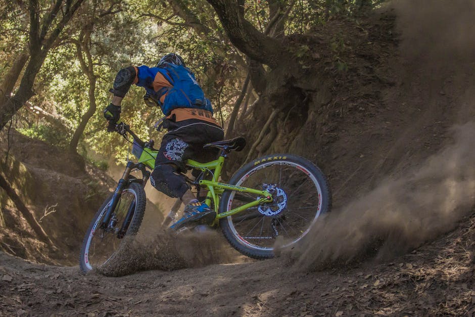 A person riding a mountain bike on a trail with a beautiful landscape.